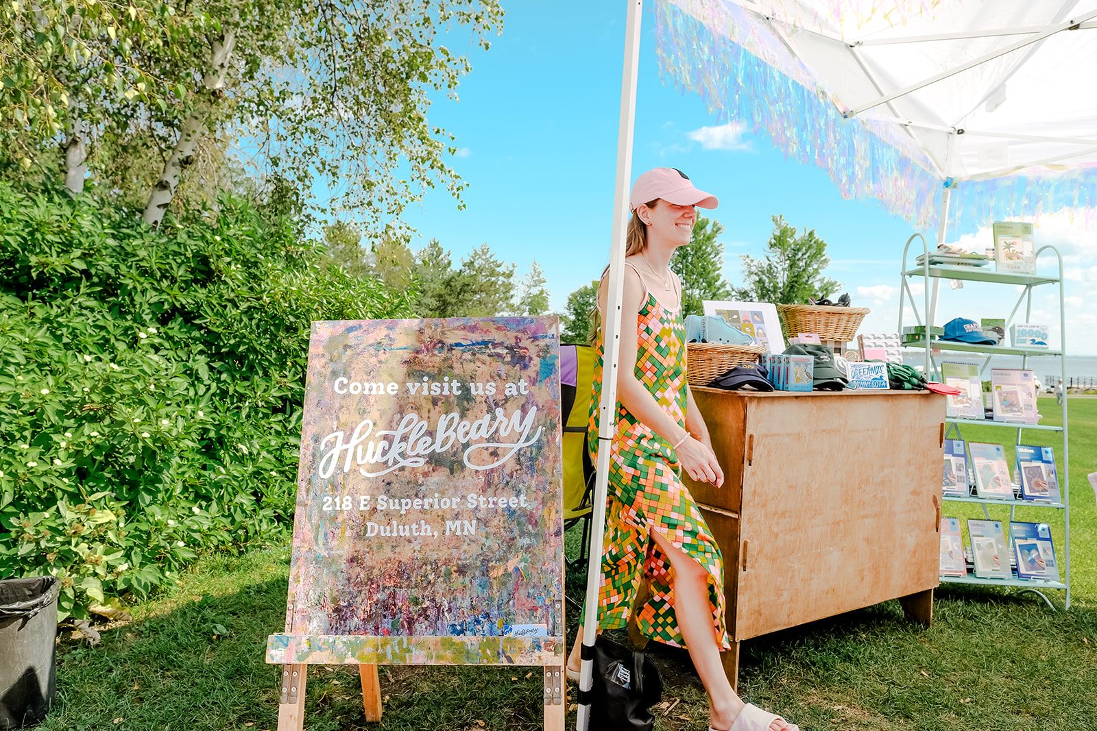 A vendor booth with the HuckleBeary sign at Flock Art Fest