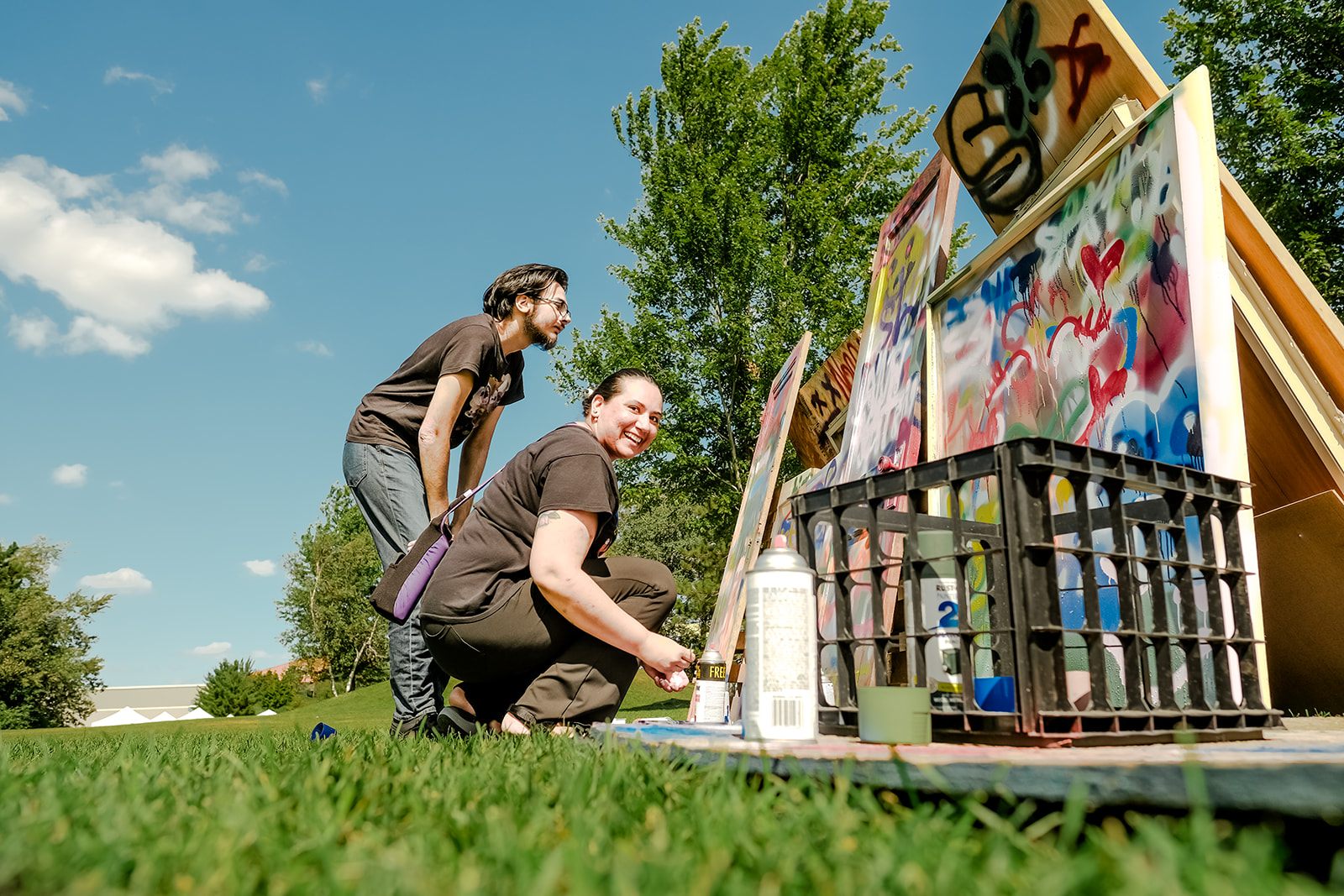 Artists creating live spray-paint art at the festival